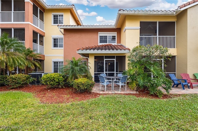 rear view of property featuring a patio area, a yard, and central AC unit