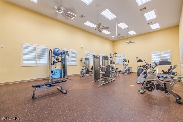 workout area featuring ceiling fan and a high ceiling