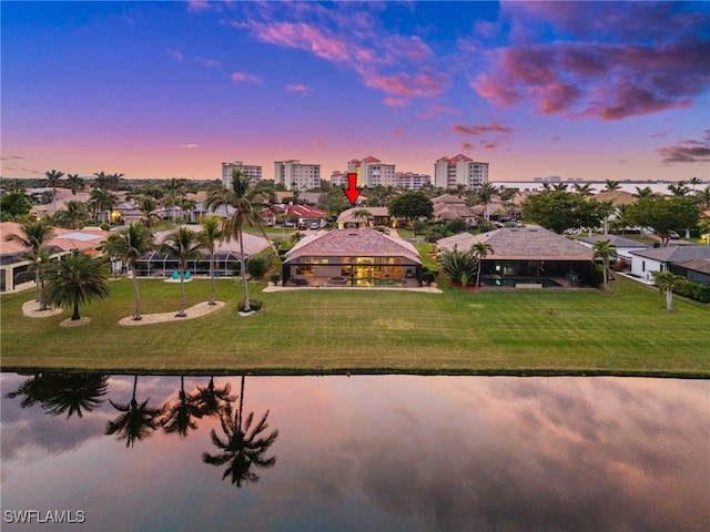 aerial view at dusk with a water view