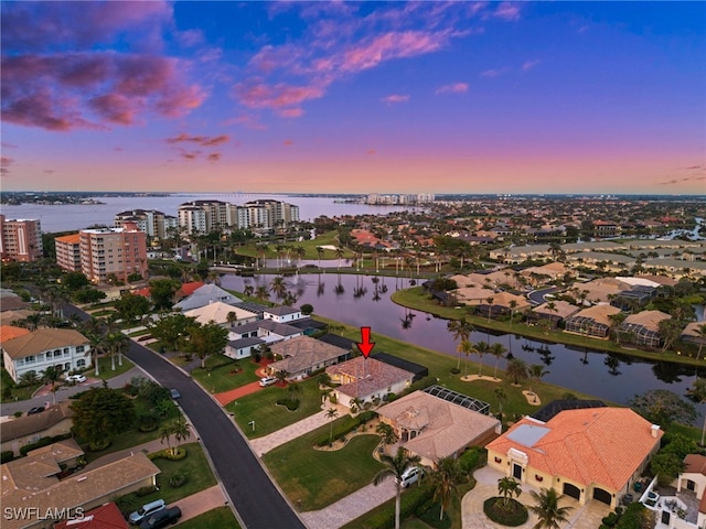 aerial view at dusk with a water view