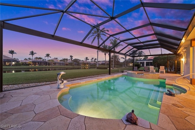 pool at dusk featuring a yard, a patio, glass enclosure, and an in ground hot tub