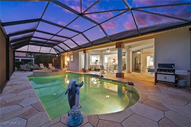 pool at dusk featuring an in ground hot tub, a lanai, ceiling fan, and a patio