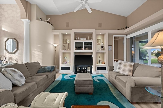 living room featuring ceiling fan, high vaulted ceiling, and built in shelves