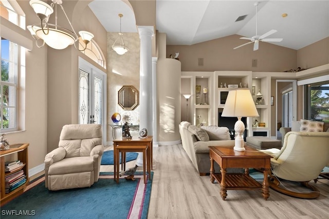 sitting room featuring hardwood / wood-style flooring, high vaulted ceiling, ornate columns, and ceiling fan