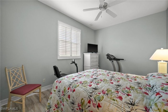 bedroom with ceiling fan and light hardwood / wood-style floors