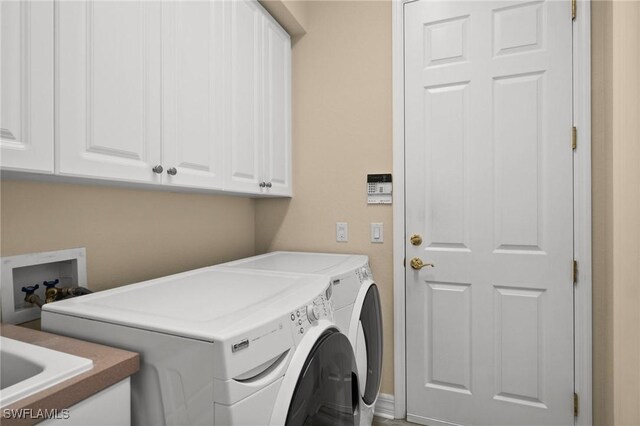 laundry room with cabinets and separate washer and dryer