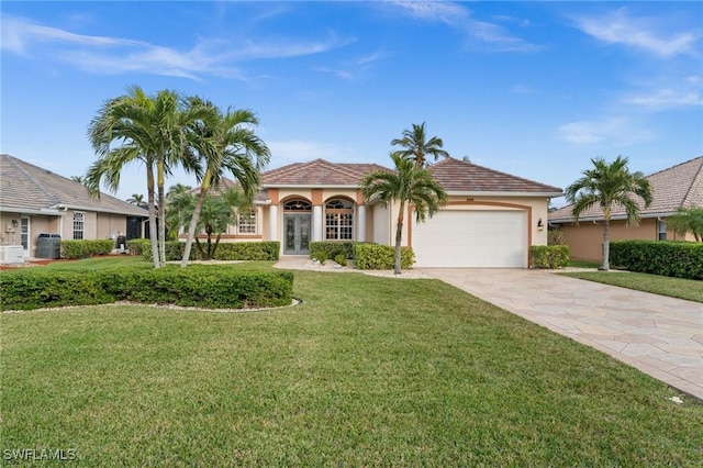 view of front of house featuring a front lawn, a garage, and french doors