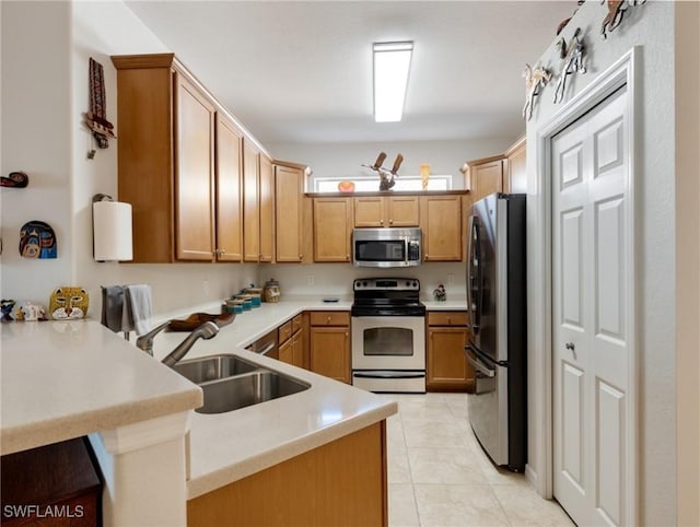 kitchen with kitchen peninsula, stainless steel appliances, light tile patterned flooring, and sink