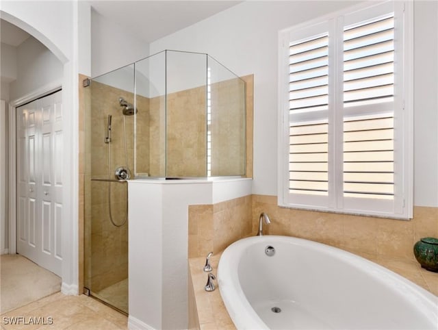 bathroom featuring shower with separate bathtub and tile patterned floors