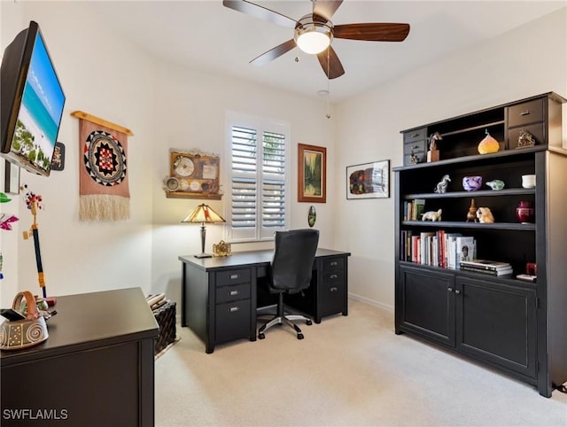 carpeted home office with ceiling fan