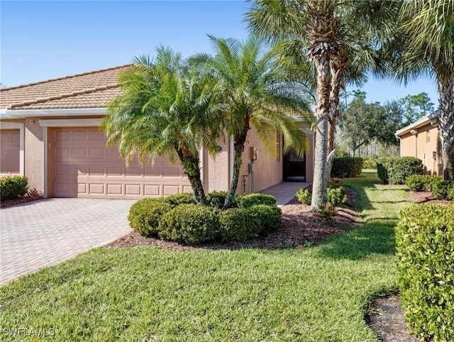 view of front facade with a front yard and a garage