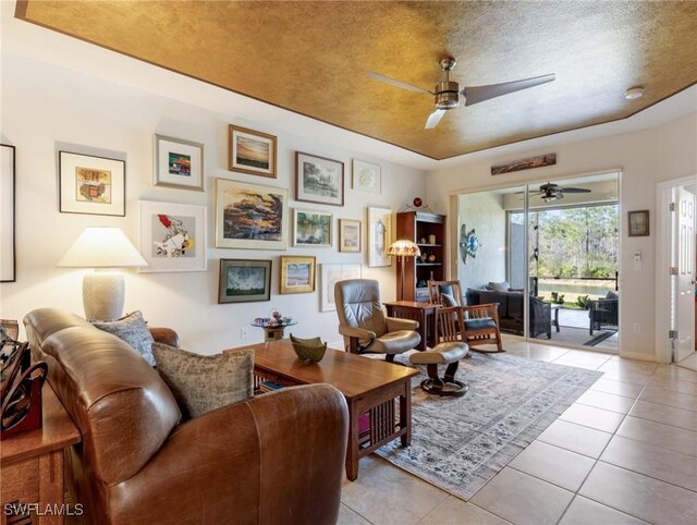 tiled living room with ceiling fan