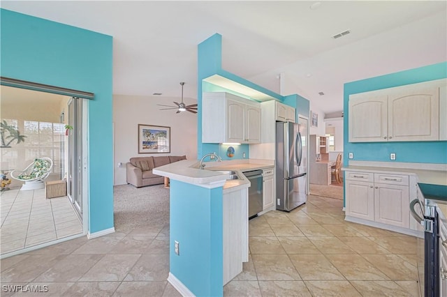 kitchen with stainless steel appliances, kitchen peninsula, light tile patterned floors, ceiling fan, and sink