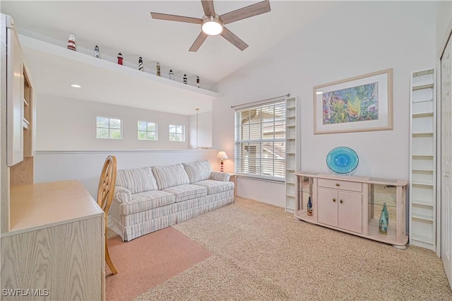 living room with ceiling fan, vaulted ceiling, and light carpet