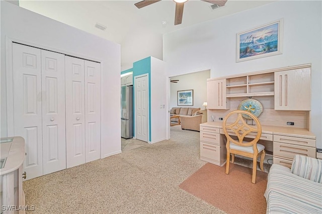 carpeted office space with ceiling fan