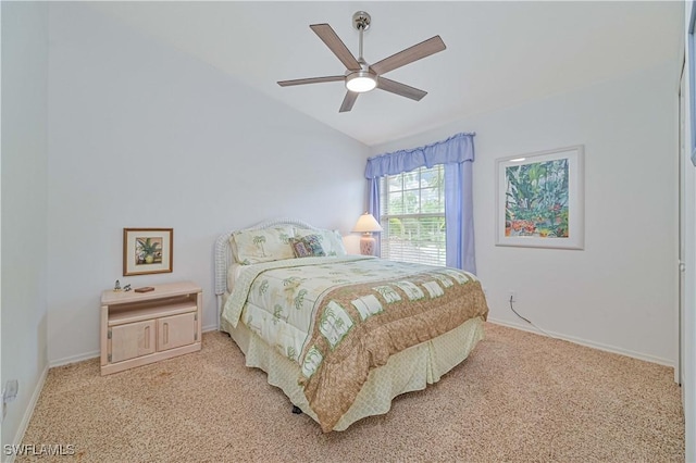 bedroom with ceiling fan, light colored carpet, and vaulted ceiling