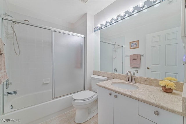 full bathroom with toilet, bath / shower combo with glass door, tile patterned floors, and vanity