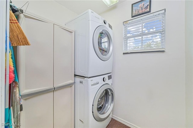 laundry room featuring stacked washer / drying machine