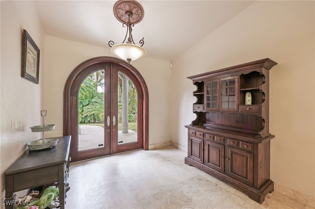 entryway with lofted ceiling and french doors