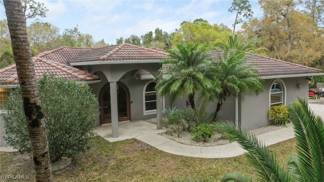 mediterranean / spanish home featuring a patio