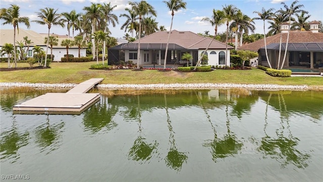 dock area featuring a water view, a lawn, and glass enclosure