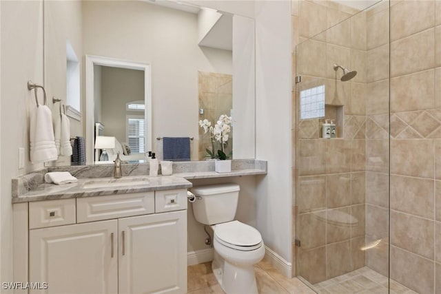 bathroom with toilet, vanity, tile patterned floors, and a shower with door