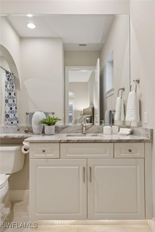 bathroom with toilet and vanity