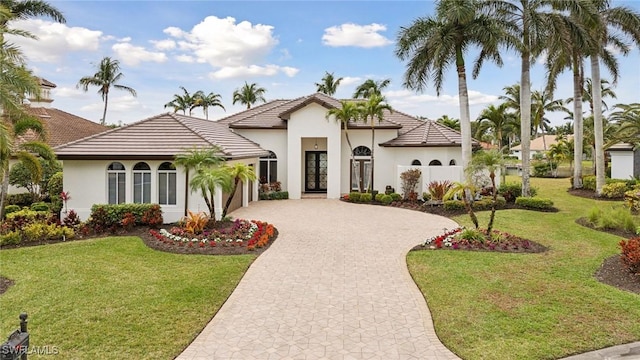 mediterranean / spanish house featuring a front lawn