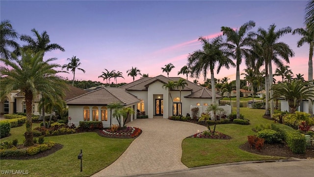 mediterranean / spanish-style home featuring a lawn