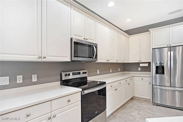 kitchen featuring white cabinetry, appliances with stainless steel finishes, and light tile patterned flooring