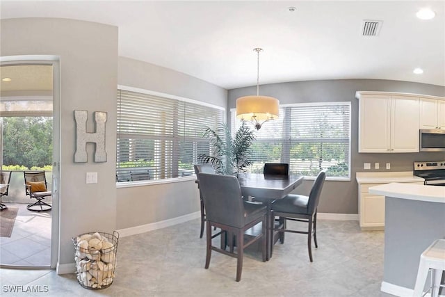 dining room featuring light tile patterned floors and plenty of natural light