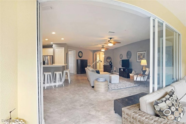 living room featuring ceiling fan and light tile patterned flooring