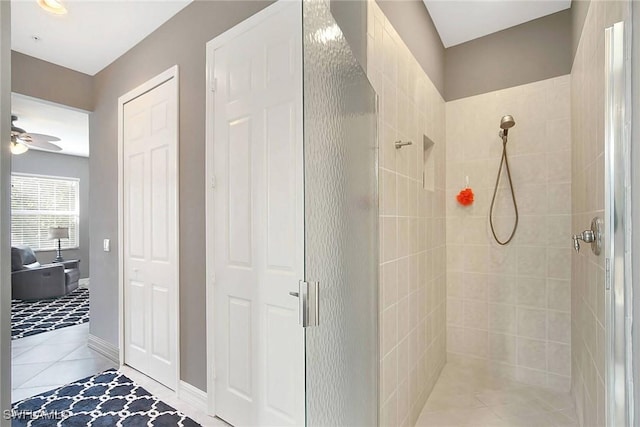 bathroom featuring walk in shower, ceiling fan, and tile patterned floors