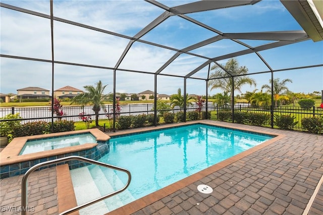 view of pool featuring glass enclosure, a patio area, and an in ground hot tub