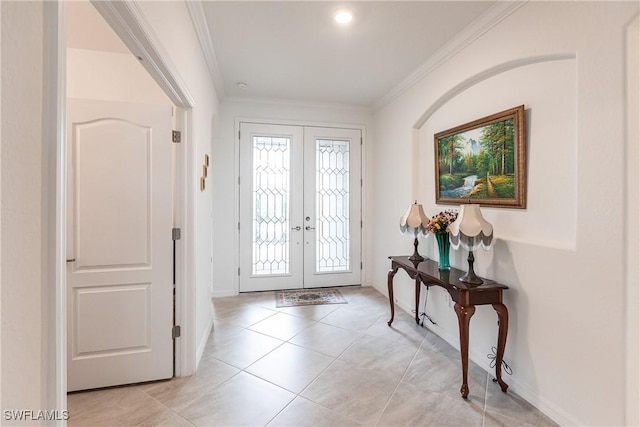 tiled foyer featuring crown molding and french doors