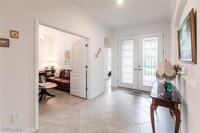 tiled entrance foyer with a wealth of natural light, crown molding, and french doors