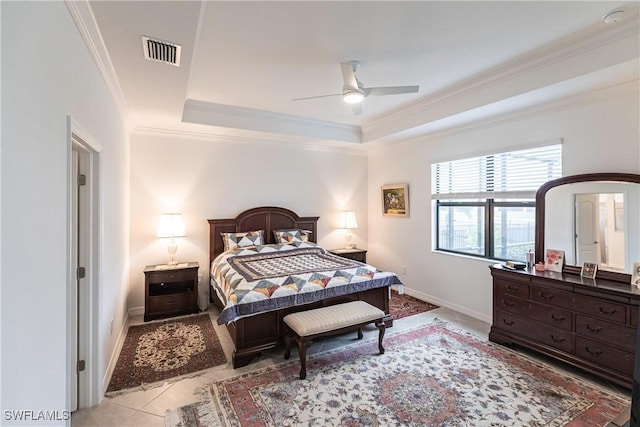 tiled bedroom featuring ceiling fan, crown molding, and a raised ceiling