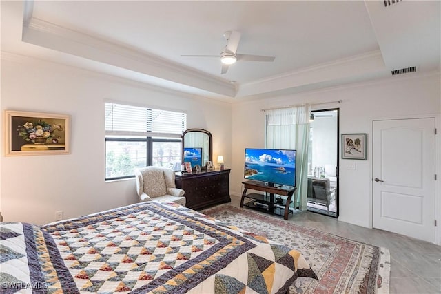 bedroom featuring ceiling fan, a tray ceiling, and ornamental molding