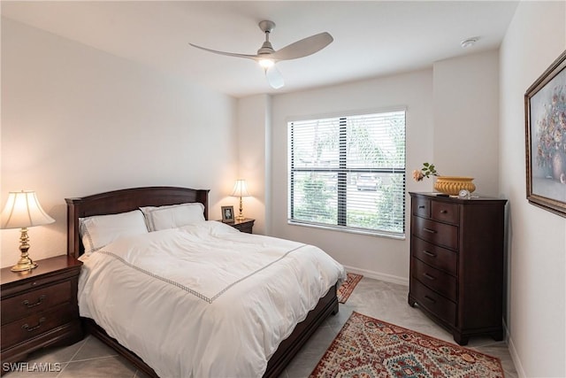 bedroom with ceiling fan and light tile patterned flooring