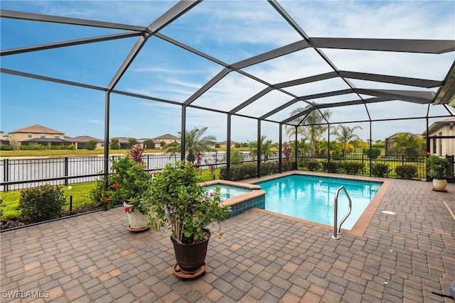 view of swimming pool featuring a patio, glass enclosure, and an in ground hot tub