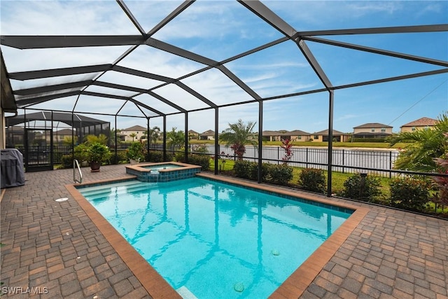 view of swimming pool featuring an in ground hot tub, a lanai, and a patio