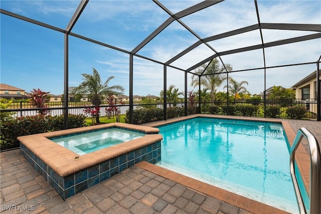 view of swimming pool with glass enclosure, an in ground hot tub, and a patio