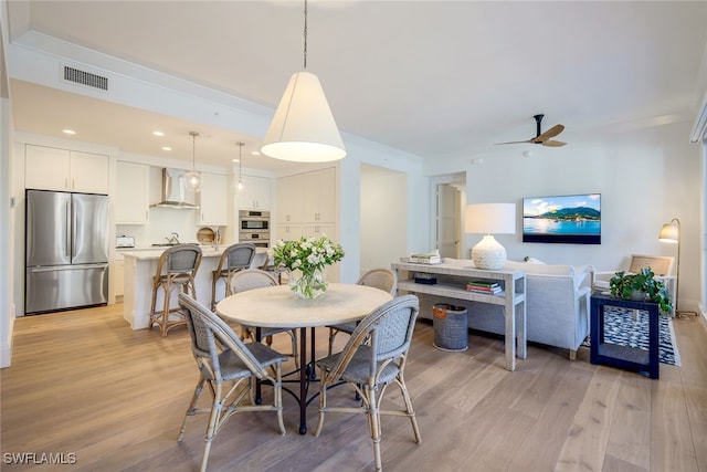 dining room featuring light wood-type flooring and ceiling fan