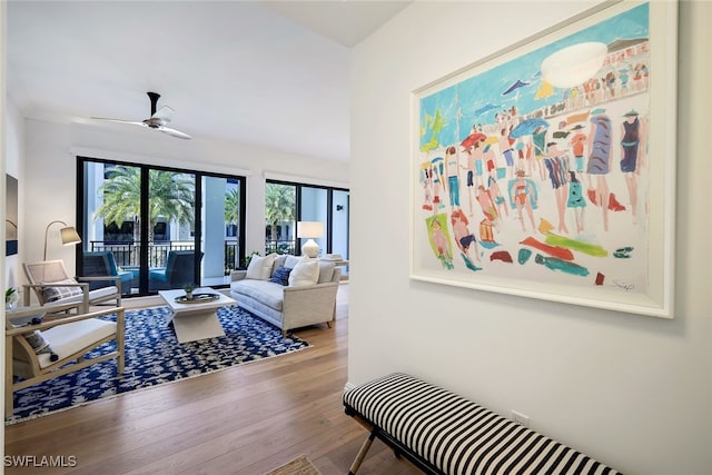 living room featuring hardwood / wood-style flooring and ceiling fan