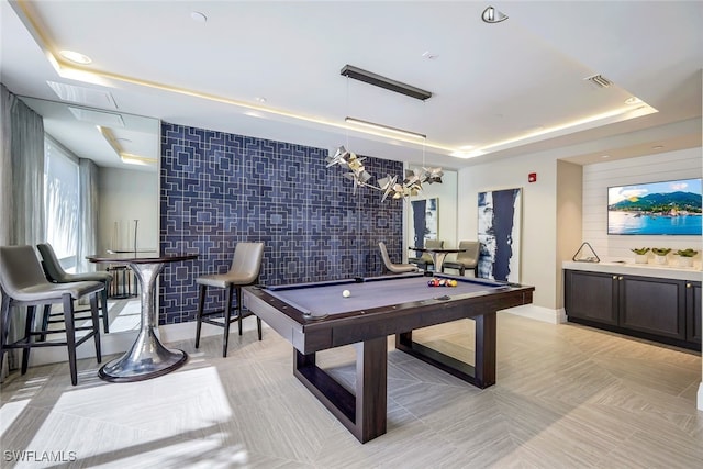 game room featuring billiards and a tray ceiling