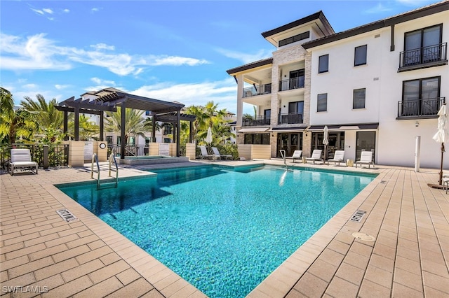 view of swimming pool featuring a pergola and a patio area