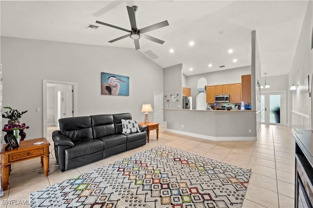 tiled living room with ceiling fan and high vaulted ceiling