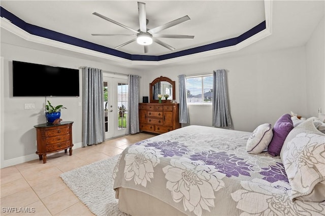 tiled bedroom with ceiling fan, french doors, access to exterior, and a tray ceiling