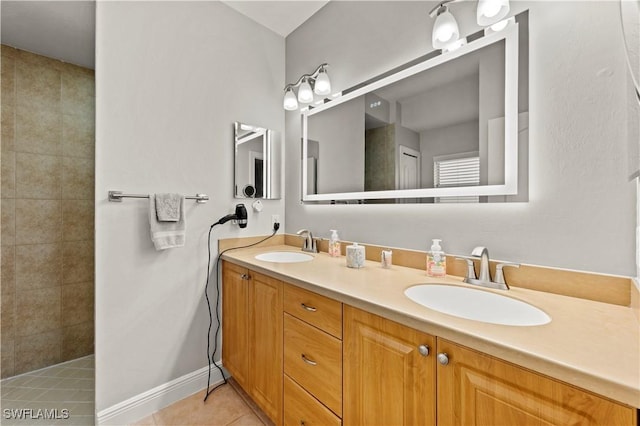 bathroom with tile patterned floors, vanity, and tiled shower