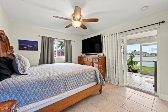 bedroom with ceiling fan, access to exterior, and light tile patterned floors